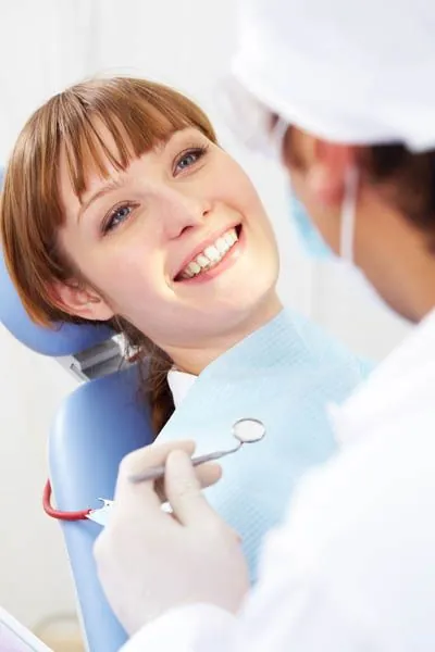 Dr. Lyu taking a look at a patient's smile