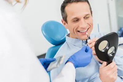 man choosing a color for his dental veneers