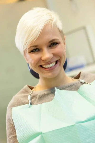 patient smiling during her oral surgery appointment
