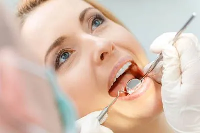 patient getting her teeth checked during a periodontal appointment at Cereus Dental Care
