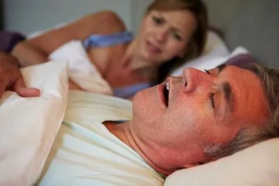 woman awake at night due to her husband's sleep apnea