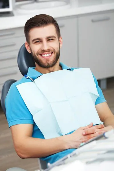 man smiling after dental bonding helped improve his smile