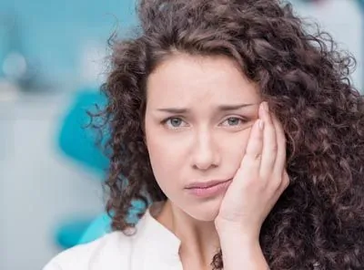 woman suffering from tooth pain